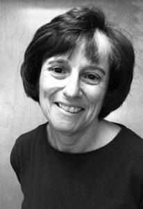 A black and white image of a white woman smiling